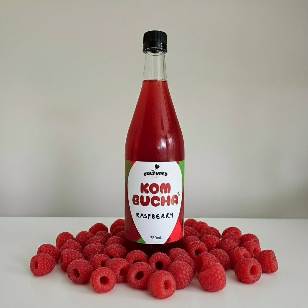 Bottle of KOM BUCHA on a light gray background